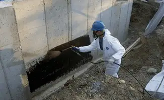 Professional waterproofing the exterior walls of the basement in Stockton, CA