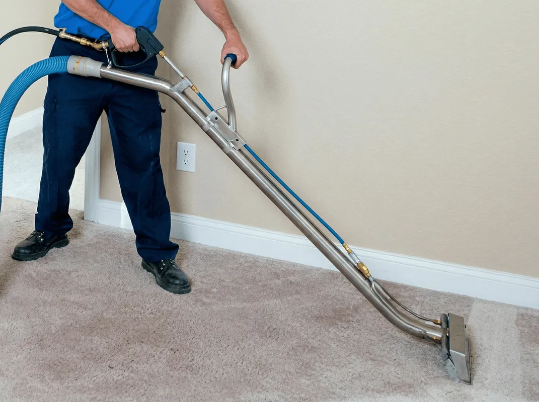 Professional operating a liquid removal machine on a carpeted floor in Stockton, CA